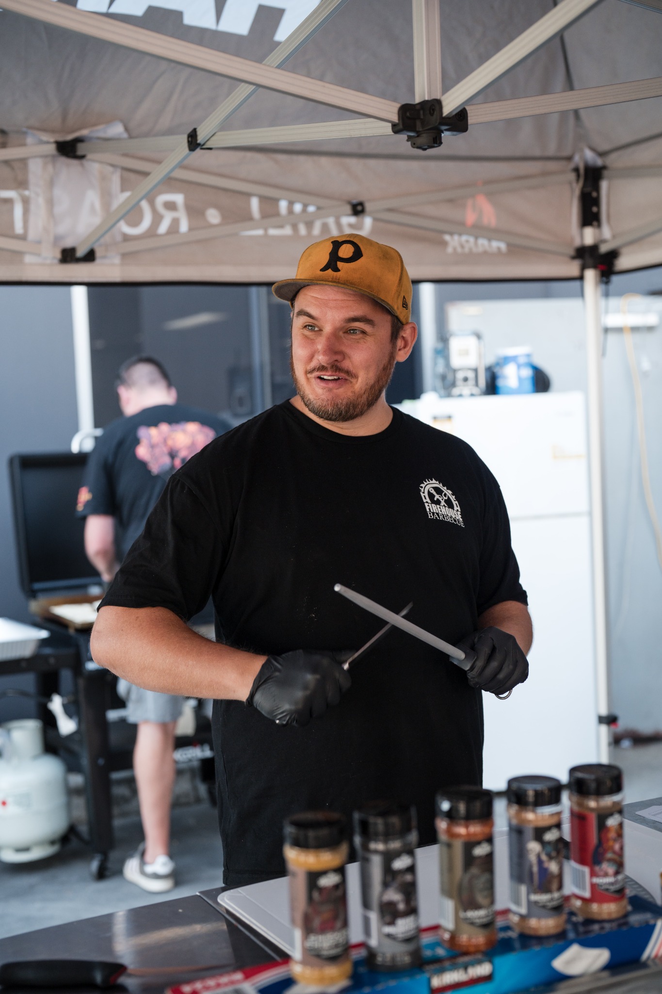 Ross teaching with barbecue tools in hand