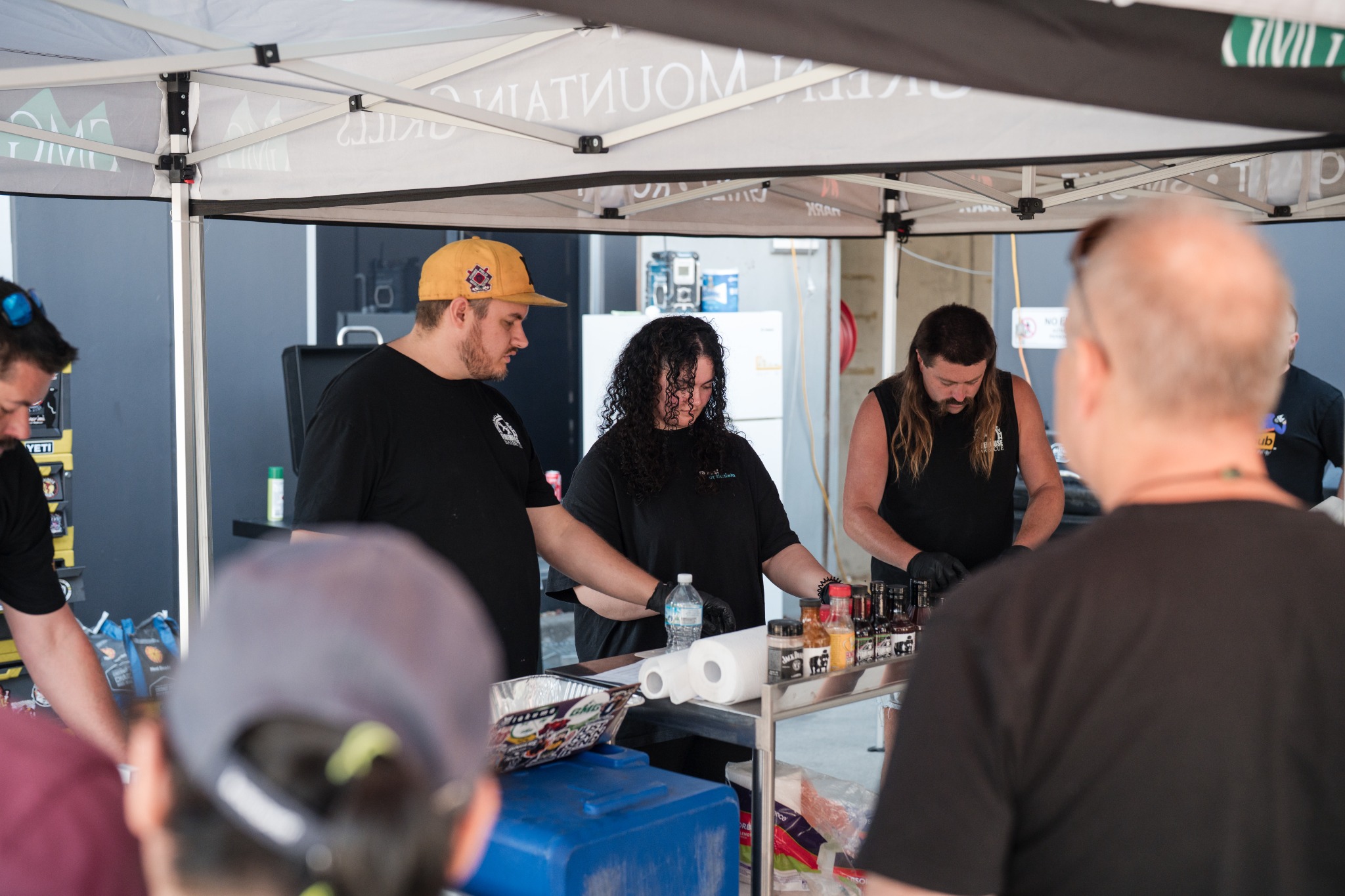 Participants working together at a Smoke School cooking station